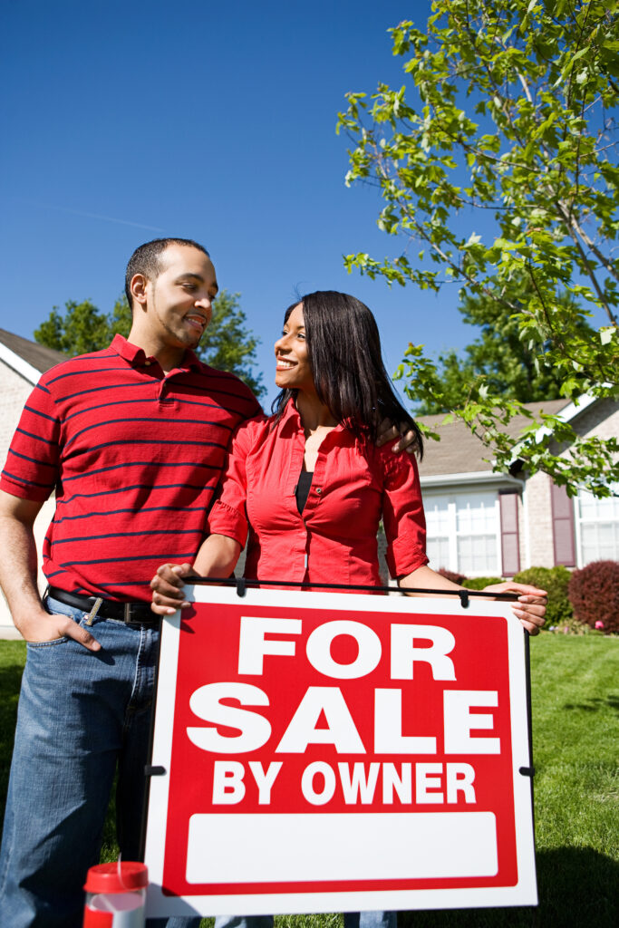 LCM Property Investments LLC.. African-American Couple in front of a home.